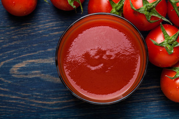 Fresh tomato juice on a blue background