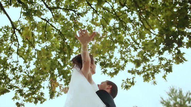 Groom lifts his bride up