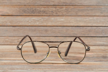 Glasses on wooden texture.