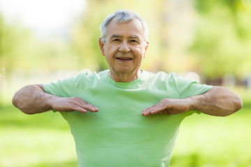 Senior man is exercising in park. Active retirement.