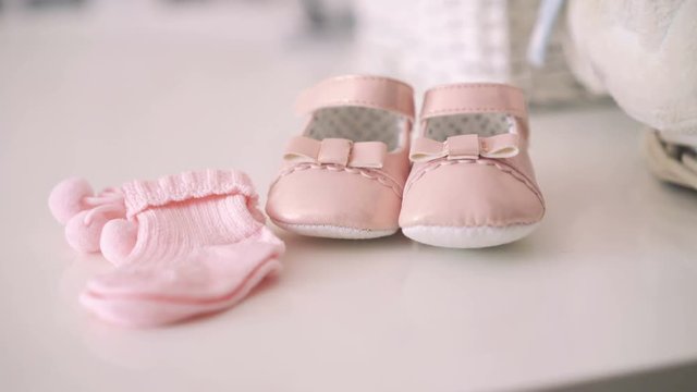 Close up of pink baby booties. 4k