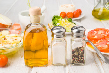 bottle of oil salt and pepper shakers on the table