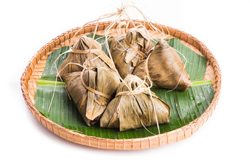 Bunch of Chinese rice dumpling placed on traditional rattan tray