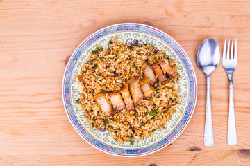 Delicious Chinese spicy fried rice with roast pork on plate
