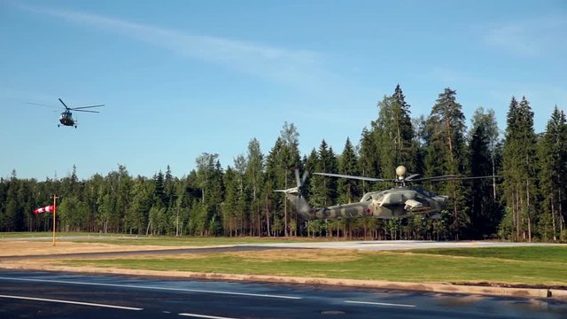 Military helicopter flying and landing.