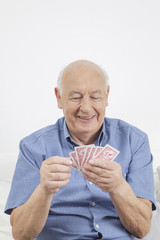 senior man playing cards stock image