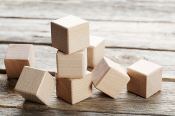 Wooden toy cubes on a grey wooden table