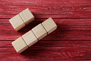 Wooden toy cubes on a red wooden table