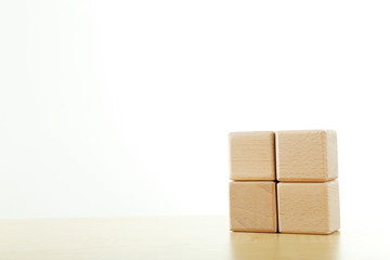 Wooden toy cubes on a brown wooden background