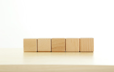 Wooden toy cubes on a brown wooden background