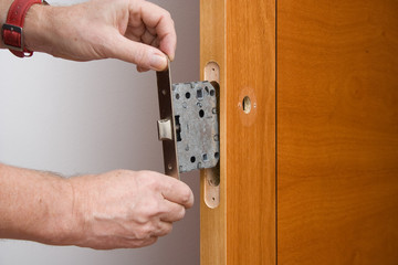 Handyman repairing a door handle