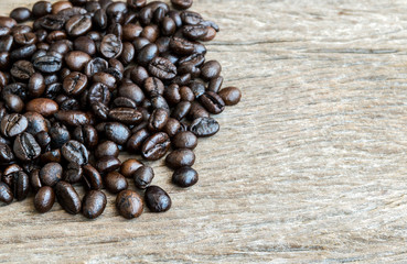 Coffee beans on old wooden background.