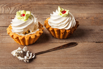 Pink cupcakes on wooden background