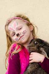 kid with face painting and rabbit animal