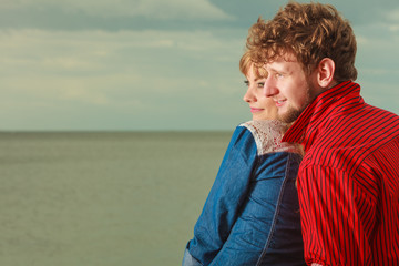Fototapeta premium Couple sitting hugged on sea shore
