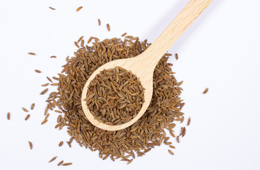 Ground cumin in a spoon.