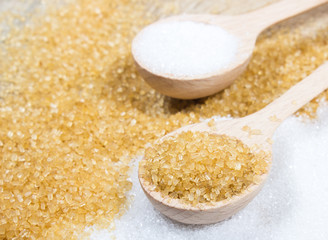 Brown sugar cane on the wooden background.