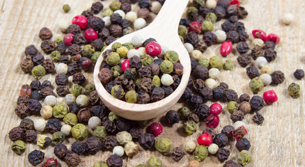 Color pepper on a wooden background.