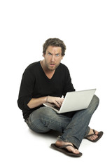 an upset man using a laptop