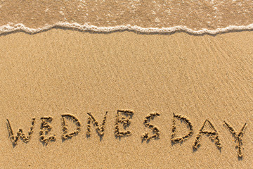 Wednesday - drawn of the hand on the beach sand, soft surf wave.