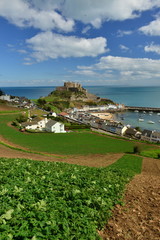 Gorey castle,Jersey, U.K.  Wide angle image of a medieval castle with habour and Jersey Royal...