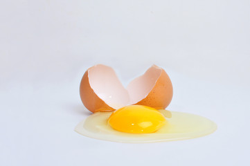 Broken egg with yolk, isolated on white background.