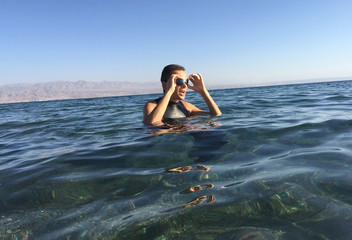 Professional triathlete practicing in open water. Swimming in se