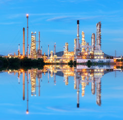 Oil refinery at twilight - petrochemical industry with water reflect
