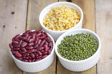 Mixed nuts in a bowl on a wooden background 