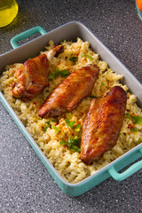 Baked spicy wings of turkey with cheese noodles.