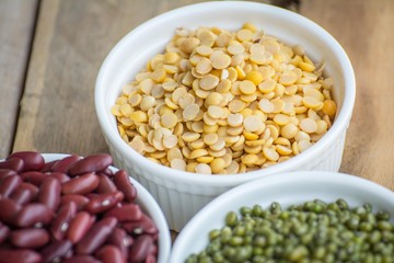 Mixed nuts in a bowl on a wooden background 