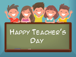 Little schoolchildren at the blackboard. Happy Teacher's Day