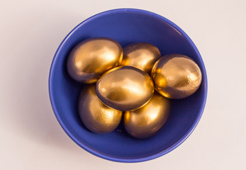 Golden eggs blue bowl