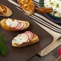 Bread Toasts with White Cheese and Radishes. Selective focus.