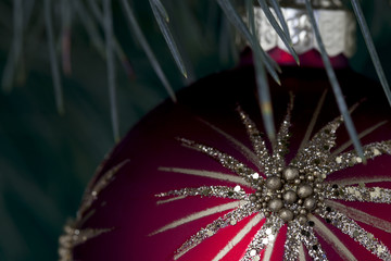 cropped image of a red christmas bulb with star shape design.