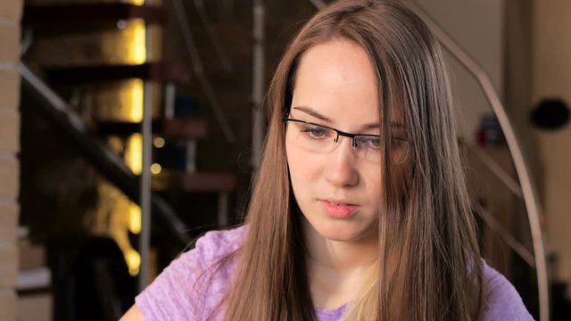 young woman is looking at computer screen, friend calls and lets know bad news