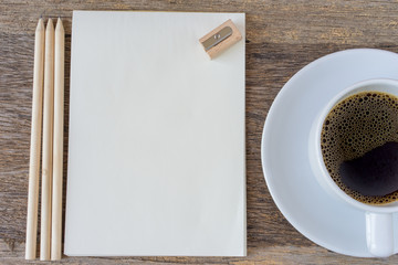 Obraz na płótnie Canvas Open notebook on wooden background with coffee cup.