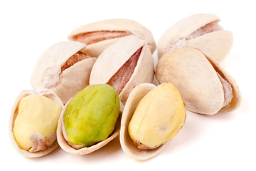 some pistachios on a white background close up