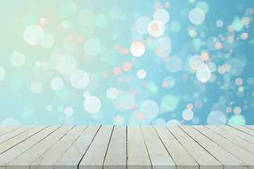 Empty wooden table or shelf wall on colorful bokeh.