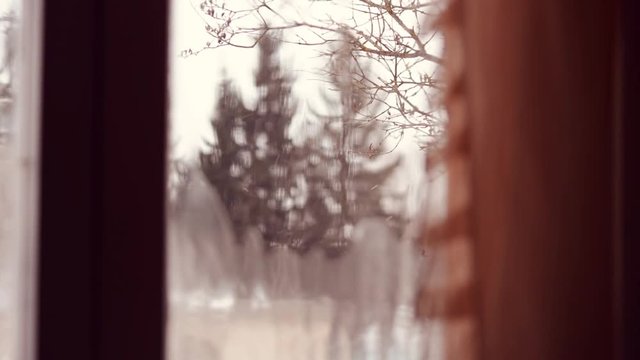 Snow falling.  Window. Nature.