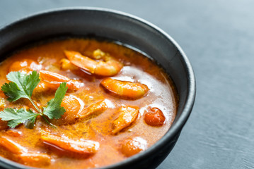 Bowl of thai yellow curry with seafood