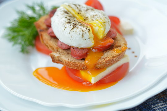 Bright poached eggand sandwich - breakfast in restaraunt 