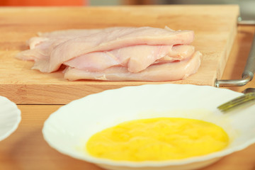 chicken breast meat on wooden board
