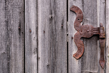 Old hinge. Rusty hinge on wooden door.