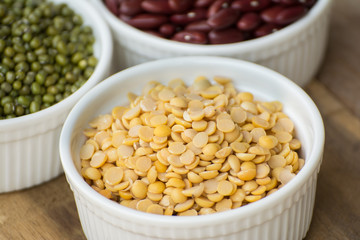 Mixed nuts in a bowl on a wooden background 