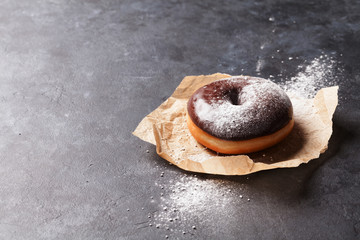 Chocolate donut with sugar powder