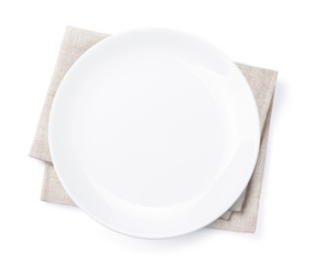 Empty plate over kitchen towel