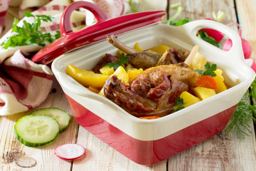 Roasted duck meat with boiled potatoes on a wooden table, select