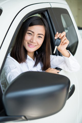 Young Happy Woman Showing The Key Of her New Car