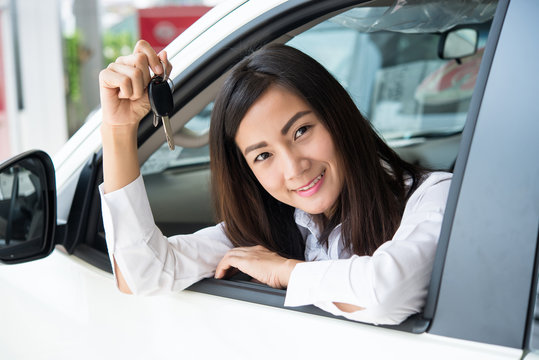 Young Happy Woman Showing The Key Of her New Car, Dream comes tr